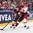 COLOGNE, GERMANY - MAY 6: Latvia's Rihards Bukarts #14 plays the puck while fending off Denmark's Markus Lauridsen #22 during preliminary round action at the 2017 IIHF Ice Hockey World Championship. (Photo by Andre Ringuette/HHOF-IIHF Images)

